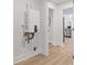 Hallway with view into an updated kitchen including stainless steel appliances and light wood floors at 3008 Ridgeside Ct, Atlanta, GA 30341