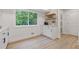 Charming kitchenette area featuring modern cabinets, floating shelves, and luxury vinyl flooring at 3008 Ridgeside Ct, Atlanta, GA 30341