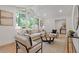 Stylish living room featuring modern decor, a cozy seating area, and soaring windows with an outdoor view at 3008 Ridgeside Ct, Atlanta, GA 30341