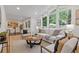 Open living room with contemporary furniture, large windows, and seamless flow into the dining area at 3008 Ridgeside Ct, Atlanta, GA 30341