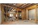 Unfinished basement with exposed wood beams and concrete foundation at 4000 Red Canoe Bnd, Lilburn, GA 30047