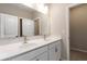 Bathroom features double sinks, white cabinetry and a large mirror at 4000 Red Canoe Bnd, Lilburn, GA 30047