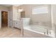 Bright bathroom featuring a soaking tub and a white vanity at 4000 Red Canoe Bnd, Lilburn, GA 30047