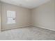 Carpeted bedroom features a window allowing for natural light at 4000 Red Canoe Bnd, Lilburn, GA 30047