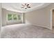 Spacious bedroom with tray ceiling, ceiling fan, and large windows overlooking the backyard at 4000 Red Canoe Bnd, Lilburn, GA 30047