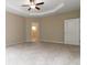 Spacious bedroom with tray ceiling and carpet floors at 4000 Red Canoe Bnd, Lilburn, GA 30047