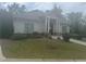Charming clubhouse features a welcoming entrance, complemented by manicured landscaping and lush green lawn at 4000 Red Canoe Bnd, Lilburn, GA 30047