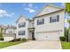 Charming two-story home featuring white siding, blue shutters, and a well-manicured lawn at 4000 Red Canoe Bnd, Lilburn, GA 30047