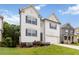 Charming two-story home featuring white siding, blue shutters, and a well-manicured lawn at 4000 Red Canoe Bnd, Lilburn, GA 30047