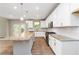 Spacious kitchen with a large island, stainless steel appliances, white cabinets and access to the outdoor deck at 4000 Red Canoe Bnd, Lilburn, GA 30047