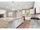 Modern kitchen with a large island, stainless steel appliances, granite countertops, and adjacent fireplace at 4000 Red Canoe Bnd, Lilburn, GA 30047