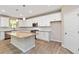 Well-equipped kitchen features white cabinetry, stainless steel appliances, granite countertops and a central island at 4000 Red Canoe Bnd, Lilburn, GA 30047