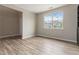 Bright and spacious living room featuring hardwood floors, neutral walls and a large window at 4000 Red Canoe Bnd, Lilburn, GA 30047