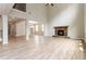 Open concept living room featuring hardwood floors, a stone fireplace and a vaulted ceiling at 4000 Red Canoe Bnd, Lilburn, GA 30047