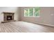 Inviting living room boasting hardwood floors, a stone fireplace, and large windows at 4000 Red Canoe Bnd, Lilburn, GA 30047