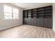Modern living room showcasing hardwood floors, built-in bookshelves and natural light from a window at 4000 Red Canoe Bnd, Lilburn, GA 30047