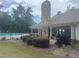 Community pool area with black fencing, stone fireplace, and covered seating under a pavilion at 4000 Red Canoe Bnd, Lilburn, GA 30047