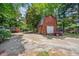 Outdoor barn featuring a garage, and driveway with plenty of parking space at 84 Nw Gloster Nw Rd, Lawrenceville, GA 30044
