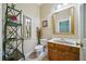 Cozy half bathroom with decorative sink, mirror and custom shelving unit at 84 Nw Gloster Nw Rd, Lawrenceville, GA 30044