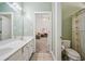 A bathroom features a dual sink vanity and an adjoining bedroom at 84 Nw Gloster Nw Rd, Lawrenceville, GA 30044