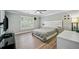 Modern bedroom with hardwood floors, white headboard, ceiling fan and window with plantation shutters at 84 Nw Gloster Nw Rd, Lawrenceville, GA 30044