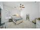 Bright bedroom with plush carpet, ceiling fan, and windows with plantation shutters at 84 Nw Gloster Nw Rd, Lawrenceville, GA 30044