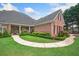 Landscaped front yard with curved walkway, mature trees, and brick exterior at 84 Nw Gloster Nw Rd, Lawrenceville, GA 30044