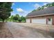 Spacious three-car garage with ample driveway parking and lovely manicured garden at 84 Nw Gloster Nw Rd, Lawrenceville, GA 30044