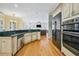 A spacious kitchen features wood floors, granite countertops, and stainless steel appliances at 84 Nw Gloster Nw Rd, Lawrenceville, GA 30044