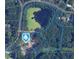 An aerial view showcases the property lines, verdant surroundings, and a private pond at 1382 Varner Rd, Marietta, GA 30062