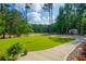 A lush lawn and picturesque pond view enhance this home's serene backyard setting at 1382 Varner Rd, Marietta, GA 30062