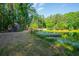 Lakeside property featuring a dock, cozy cabin, and lush trees perfect for nature lovers and outdoor recreation at 1382 Varner Rd, Marietta, GA 30062