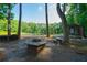 Picturesque backyard scene featuring a cozy gazebo, a fire pit and a serene lake, perfect for outdoor relaxation at 1382 Varner Rd, Marietta, GA 30062