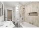 Bright bathroom featuring modern fixtures and vanity, with a shower-tub combo at 1382 Varner Rd, Marietta, GA 30062