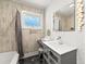 Stylish bathroom featuring decorative walls, modern vanity, and unique lighting fixtures at 1382 Varner Rd, Marietta, GA 30062