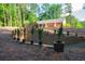 Exterior view of an earth-sheltered house with terraced retaining walls and lush landscaping at 1382 Varner Rd, Marietta, GA 30062