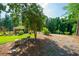 Scenic home exterior with a lush lawn, and a gravel driveway blending nature and comfort for tranquil living at 1382 Varner Rd, Marietta, GA 30062
