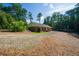 Charming home exterior features a sprawling yard with towering trees offering a peaceful and inviting atmosphere at 1382 Varner Rd, Marietta, GA 30062