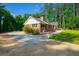 Charming single-story brick home with a well-manicured lawn, mature trees, and paved driveway at 1382 Varner Rd, Marietta, GA 30062