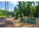 Charming backyard garden with raised metal planters and a picturesque white greenhouse at 1382 Varner Rd, Marietta, GA 30062