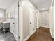 Hallway with three doors and view of vanity with grey cabinet and sink at 1382 Varner Rd, Marietta, GA 30062