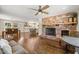 Cozy living room with a brick fireplace, ceiling fan, and hardwood floors at 1382 Varner Rd, Marietta, GA 30062