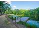 Picturesque pond view featuring a wooden pier extending into the water, surrounded by nature at 1382 Varner Rd, Marietta, GA 30062