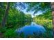 A tranquil pond surrounded by lush greenery, perfect for relaxation and enjoying nature at 1382 Varner Rd, Marietta, GA 30062