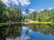 Scenic view of a lush, tree-lined pond with reflections, near a charming lakeside home at 1382 Varner Rd, Marietta, GA 30062