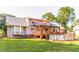 Exterior of home featuring large, grassy backyard with deck, patio, and above-ground pool at 184 Wildflower Dr, Social Circle, GA 30025