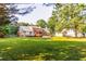 Large, grassy backyard with mature trees and well-maintained lawn at 184 Wildflower Dr, Social Circle, GA 30025