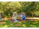 Spacious backyard featuring a wooden playset with a slide and a swing set for outdoor fun at 184 Wildflower Dr, Social Circle, GA 30025