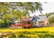 Large backyard with a deck, above ground pool and mature trees provides a private outdoor retreat at 184 Wildflower Dr, Social Circle, GA 30025
