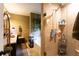 Tiled bathroom with a glass door shower, bathtub, and decorative elements at 184 Wildflower Dr, Social Circle, GA 30025